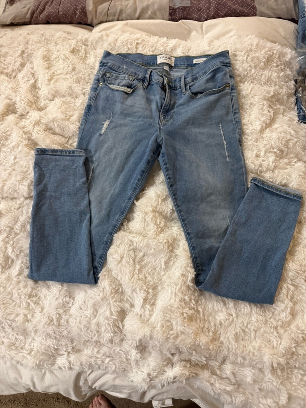 Frame Denim Light Wash Skinny Jeans with Subtle Distress